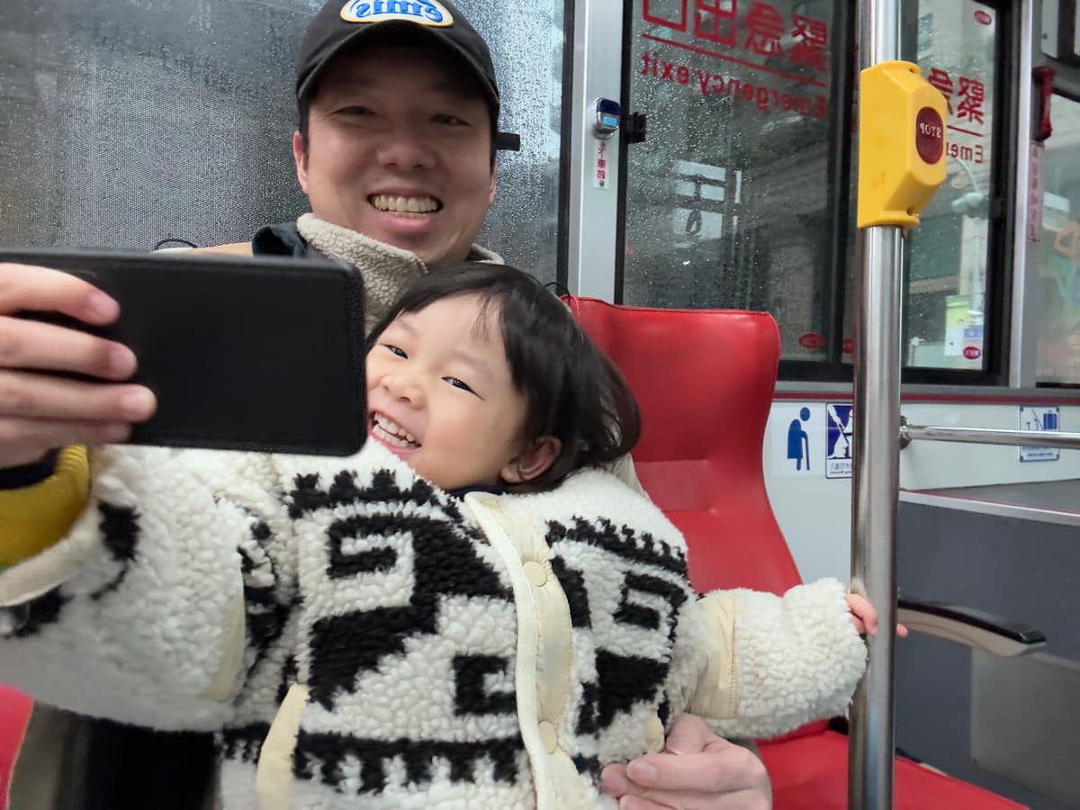 Parent-child selfie moment on the bus